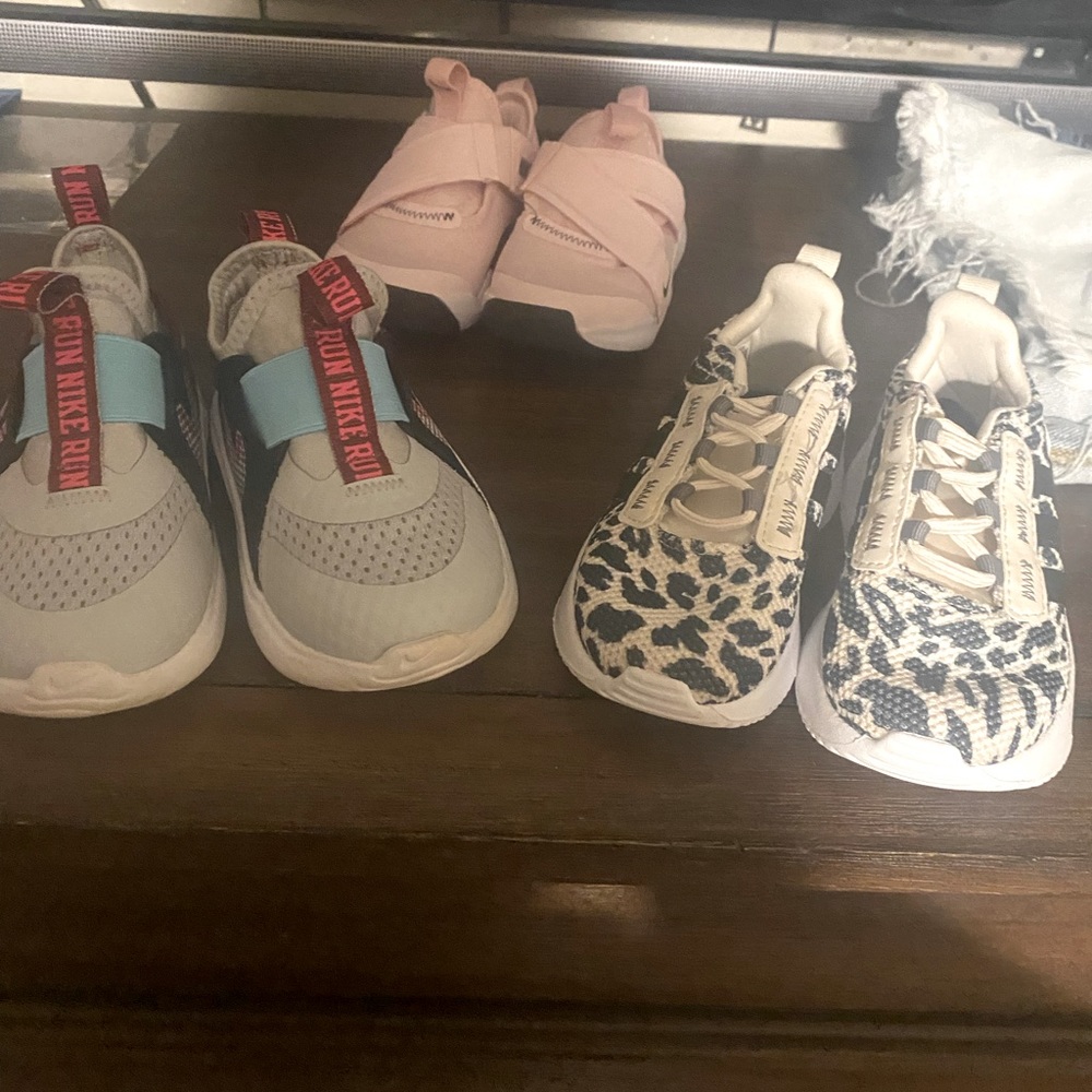 Three pair of toddler girl size 7 tennis shoes.